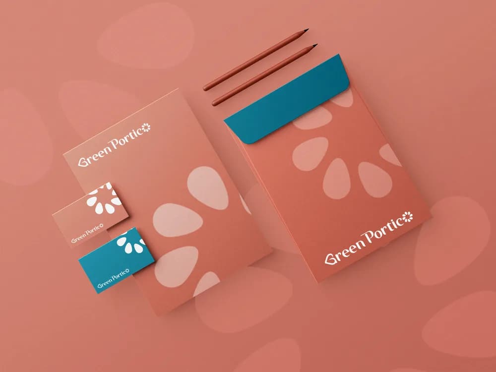 Green Portico — Identity and printed collateral built on a soft botanical pattern and a warm terracotta palette.